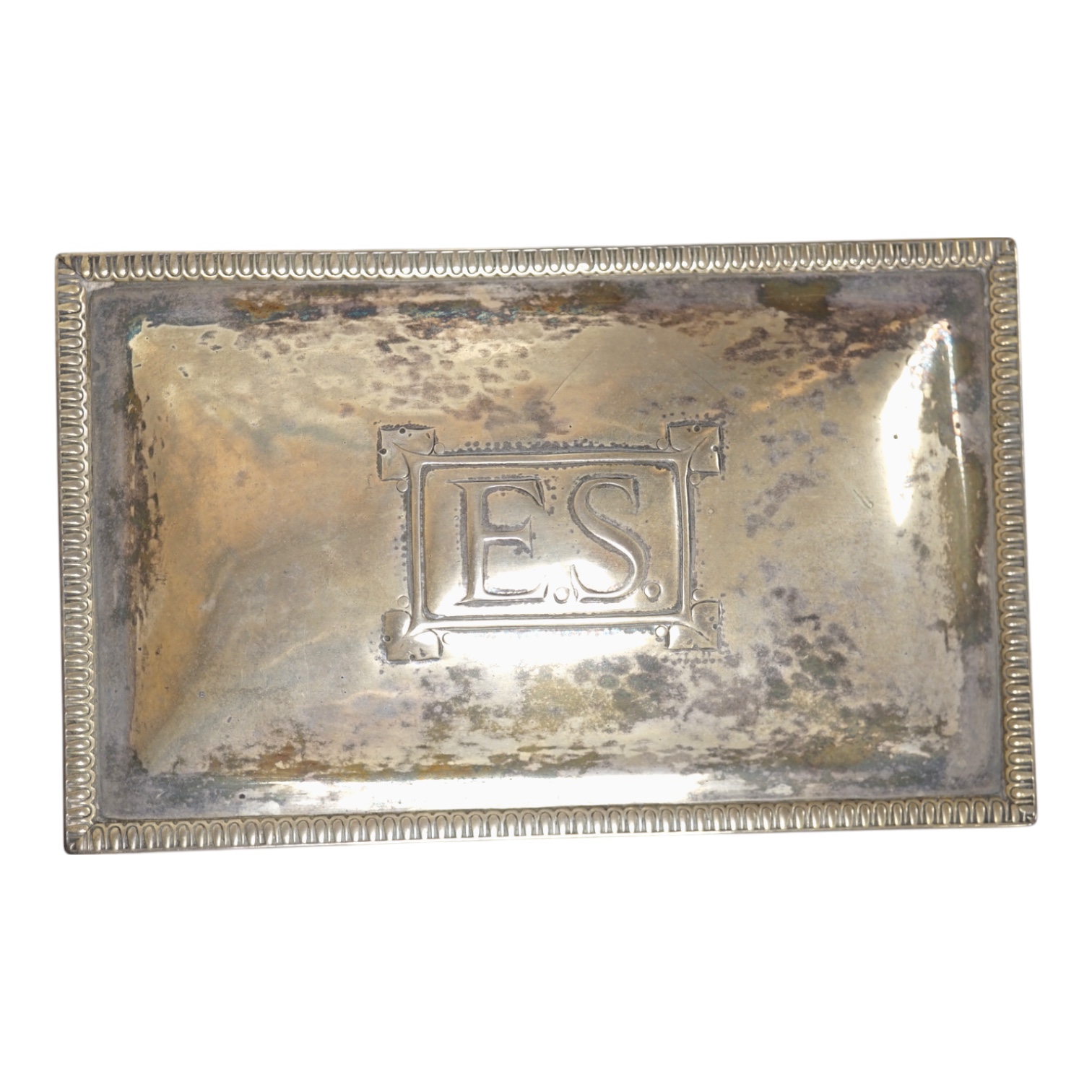 A George V Arts & Crafts silver mounted rectangular cigarette box, by Dryad Metal Works, Birmingham, 1924, on ball feet, the cover initialled ES, 15.2cm. Condition - fair